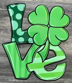 the letter v is painted in green and has a shamrock on it's side