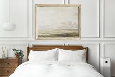 a bed with white linens and a painting on the wall