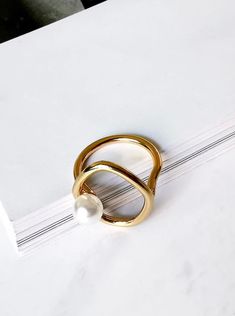 Pearl loop designed ring color: gold base: brass size: 6-6.5 Trendy Gold Metal Rings, Minimalist Gold Pearl Ring With Detail, Gold Minimalist Pearl Ring, Gold Open Midi Rings, Chic Gold Open Midi Rings, Trendy Gold Pearl Ring Gift, Gold Circular Metal Ring Jewelry, Modern Twist Gold Open Ring Jewelry, Gold Open Ring With A Modern Twist