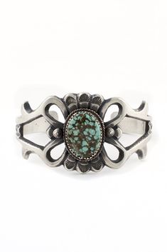 This beautiful sandcast sterling silver cuff bracelet features an oval centerpiece of genuine, greenish blue Turquoise. Sandcast sterling silver jewelry is a unique style of jewelry. The surface has a patina with a soft sheen and a brushed look. The bracelet has shapes and swirls that have an “Old Spain” appearance. Sandcast jewelry is made with a generous amount of sterling silver and has a high quality feel and weight. It is a labor-intensive process that involves many steps and is truly an au Navajo Turquoise Jewelry, Turquoise Silver Bracelet, Silver Turquoise Jewelry, Silver Eagle, Navajo Jewelry, Greenish Blue, Turquoise Cuff, Oxidised Jewellery, Sterling Silver Cuff Bracelet