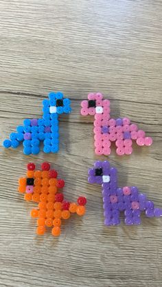 four different colored beads are arranged in the shape of letters