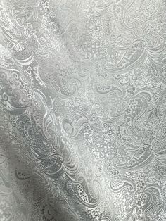 a silver fabric with an intricate design on it