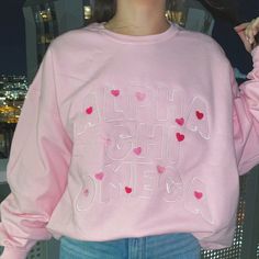 This baby pink or sand crewneck will have your sorority spelled out in a full front embroidered design surrounded with hearts (& love!), just pick your size, color and sorority and we will take care of the rest! <3    ***Due to nationwide stock shortages, we have several different manufacturers for our pink crew Pink Sorority Letters Sweatshirt, Sorority Crewneck Designs, Sorority Embroidery, Rush Sorority, Sorority Clothing, Embroidered Sorority Sweatshirts, Sorority Crewneck, Pink Sorority, Sorority Embroidered Sweatshirt