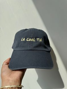 We all have that one cool tía... or you are the cool tía! Show all the Tías appreciation this Mother's Day for being great role models with this tee? * Vintage Navy Cap/ Butter Yellow Thread   * Unisex Fit  * Embroidered with love by JZD in Brownsville, TX * Made to order. Please allow 7-10 days. Our small but mighty team is pouring so much love in to these for all our tías. Fun Black Cotton Baseball Cap, Fun Cotton Hats For Streetwear, Hip Hop Dad Hat Baseball Cap For Summer, Hip Hop Dad Hat For Summer, Hip Hop Style Dad Hat Baseball Cap For Summer, Casual Pre-shrunk Snapback Dad Hat, Fun Cotton Baseball Cap With Letter Print, Fun Cotton Letter Print Baseball Cap, Fun Dad Hat With Letter Print