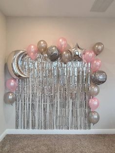 a room filled with balloons and stars on the wall