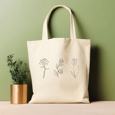 "Our tote bag is perfect for anyone who loves nature-inspired accessories. This floral line art tote bag is trendy and perfect for plant and flower enthusiasts. It is also a great gift for your loved ones who appreciate unique and chic fashion pieces. Whether you're a student, a working professional, or a fashion enthusiast, this tote bag is the perfect addition to your collection. ‣ Tap here to head back to the shop: https://www.etsy.com/shop/FukuDesignsUS ‣ Follow us on: IG - https://www.instagram.com/fukudesignsus/ Pinterest - https://www.pinterest.com/fukudesignsus/ ‣ Reach out to us for any questions that you have about our items. We are here to provide quality products and service to you. SHIPPING AND PRODUCTION TIME Returns are not accepted, but if you do have a concern, please reac Rectangular Bags With Plant Print For Daily Use, Everyday Rectangular Bag With Plant Print, White Botanical Tote Bag, Botanical White Tote Bag, White Botanical Rectangular Bag, Plant Print Tote Bag As Gift, Plant Print Tote Bag For Gift, Botanical Bags With Plant Print For Everyday Use, Botanical Bags With Plant Print And Rectangular Shape