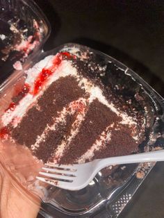 a piece of cake in a plastic container with a fork