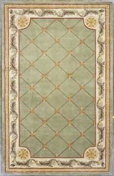 a rug with an ornate design on the front and sides, in light green color