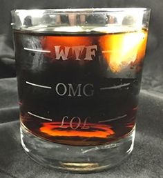 a glass filled with liquid sitting on top of a table