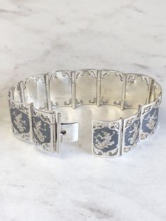 "Sterling Silver Lady's Wide Bracelet with custom etchings and design work over an oxidized hinged plates all jointed together. This bracelet has a hidden style clasp that shows a continuous pattern and is 7/8\" wide and 7\" in length. This is truly a One-Of-A- Kind Custom-made Bracelet. This item would Retail for $725.00" Ornate Engraved Sterling Silver Bracelet For Anniversary, Etched Sterling Silver Bracelet For Formal Occasions, Formal Etched Sterling Silver Bracelet, Ornate Silver Jewelry With Engraving Option, Formal Sterling Silver Bracelets With Engraving Option, Ornate Engraved Sterling Silver Bracelet, Antique Engraved Sterling Silver Bracelet, Silver Etched Bracelets For Ceremonial Occasions, Silver Etched Bracelet For Ceremonial Occasions