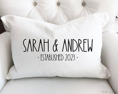 a white couch with a pillow that says, sarah and andrew established 2012