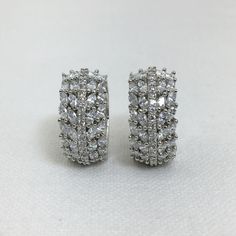 Elevate your style with our stunning Diamond Huggies from SapphireArtTreasure. These American Diamond-encrusted earrings feature wide hoops that add a touch of modernity and elegance to any ensemble. With their timeless design and sparkling allure, these Diamond Huggies are perfect for both casual and formal occasions. Make a statement and exude confidence with these exquisite earrings that will surely turn heads wherever you go. *𝐏𝐑𝐎𝐃𝐔𝐂𝐓 𝐃𝐄𝐓𝐀𝐈𝐋* * Material: Brass * Plating: White R Anniversary Clip-on Earrings With Diamond Accents, Diamond White Cubic Zirconia Clip-on Earrings For Anniversary, White Cubic Zirconia Huggie Earrings For Wedding, Wedding White Cubic Zirconia Huggie Earrings, White Gold Huggie Earrings With Sparkling Cubic Zirconia, White Cubic Zirconia Cluster Earrings For Anniversary, Dazzling Sparkling Crystal Earrings For Anniversary, Silver Huggie Earrings With Diamond Accents For Wedding, Cubic Zirconia Hoop Earrings With Prong Setting As Gift