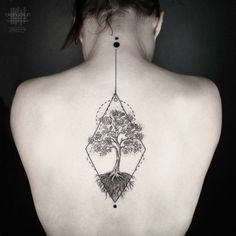 a woman with a tree tattoo on her back