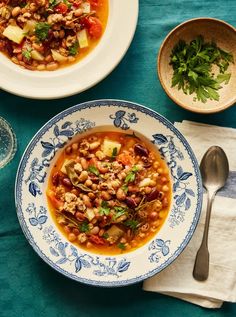 two bowls of soup on a blue table cloth