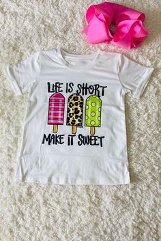 Top features 3 cute popsicles with different fun and perfect for summer prints on a solid white background t-shirt. Short sleeve normal daily wear. Super soft material, comfortable and easy. Add a sweet to her look with this printed short-sleeve top. Good to match a denim pant/shorts for spring and summer season. The prints design adds a playful design touch to her wardrobe. Breathable fabric keeps you cool and comfortable, while the pullover style makes it easier to wear. Material: Polyester and Spandex. Includes: Top White Printed T-shirt For Summer, Playful Tops With Sublimation Print For Summer, White Sweet Tops For Summer, Sweet White Summer Tops, Cute White Short Sleeve T-shirt, Trendy White T-shirt With Cartoon Print, Sweet White Short Sleeve Top, Fun White T-shirt, Playful White T-shirt With Graphic Print