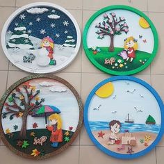 four hand painted plates sitting on top of a tile floor next to each other with children's artwork on them