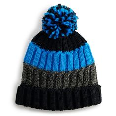 a blue and black knitted hat with a pom - pom on top