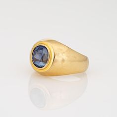 This is part of Chairish’s Fine Jewelry assortment.  Stylish vintage natural Ceylon sapphire signet ring (circa 1990s) crafted in 18 karat yellow gold.   Oval mixed cut natural sapphire measures 8.5mm x 7.8mm x 6.6mm (estimated at 3.50 carats). The sapphire is medium blue in colour, lightly included, good cut and bezel set in the centre. Colour and inclusions are typical of sapphires from Ceylon (Sri Lanka). There is no evidence of any treatments to the stone.     Included with the purchase of t Classic Domed Sapphire Ring With Polished Finish, Classic Domed Sapphire Ring, Yellow Gold Sapphire Signet Ring With Polished Finish, Classic Oval Sapphire Ring With Smooth Bezel, Formal Yellow Gold Domed Sapphire Ring, Classic Domed Sapphire Ring Gift, Polished Yellow Gold Sapphire Ring For Formal Events, Polished Yellow Gold Sapphire Ring For Formal Occasions, Timeless Yellow Gold Topaz Ring With Polished Finish