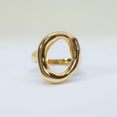 add a touch of elegance and confidence to your ensemble with our Saturday Sun Ring. this statement ring features a unique, open design that will elevate any look. perfect for those seeking to make a stylish and sophisticated statement. 18k gold pvd over 316L stainless steel water resistant top of ring is 18 x 22mm band is 3mm thick Modern Dome Ring With Open Band For Formal Occasions, Modern 14k Gold-tone Rings, Modern Gold-tone Rings With Polished Finish, Modern Dome Ring With Open Band, Modern Gold-plated Gold-tone Rings, Modern Gold-tone Gold Plated Rings, Modern Gold-tone Tarnish Resistant Rings, Modern Gold-tone Gold-plated Rings, Modern Gold-tone Tarnish-resistant Rings