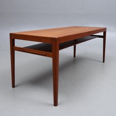 a wooden table sitting on top of a white floor