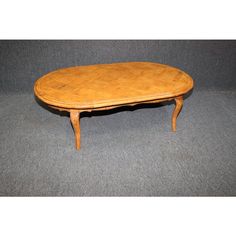 a wooden table sitting on top of a gray carpeted floor next to a wall