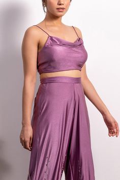 Purple crop top with cowl neckline and shoulder straps. Comes with high waisted embroidered pants.
Component: 2
Pattern: Embroidery
Type Of Work: Pearl, Sequin and Cutdana
Neckline: Cowl Neck
Sleeve Type: Sleeveless
Fabric: Lycra
Color: Purple
Other Details: 
Pants with embroidery on the hem
Shoulder straps
Closure: Side zip
Note: Blouse padded only up till size: 2XL
Occasion: Party - Aza Fashions Cropped Two-piece Party Bottoms, Party Cropped Two-piece Bottoms, Two-piece Cropped Party Tops, Chic Crop Top Set For Party, Cropped Two-piece Party Top, Chic Party Crop Top Set, Cropped Two-piece Top For Party, Chic Party Sets With Crop Top, Fitted Sleeveless Pant Set For Party