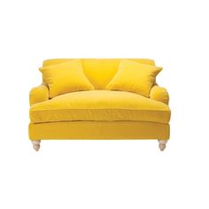 a yellow couch with two pillows on it's back and the seat upholstered