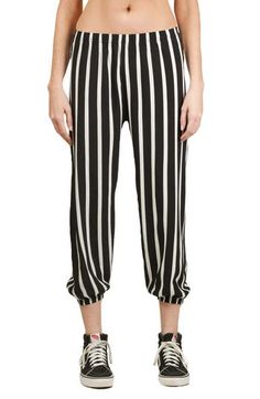 A bold take on an iconic '80s style, these laid-back pants show off contrasting stripes and relaxed balloon legs in a cropped silhouette. 21" inseam; 7 1/2" leg opening; 10 1/2" front rise; 14 1/2" back rise (size S) 100% polyester Dry clean Made in the USA Striped Tapered Leg Bottoms For Spring, Casual Striped Bottoms For Spring, Casual Spring Bottoms With Contrast Stripes, Spring Casual Bottoms With Contrast Stripes, Spring Pants With Contrast Stripes, Spring Casual Striped Bottoms, Black Pants With Elastic Cuffs For Spring, Black Bottoms With Striped Hem For Spring, Black Spring Bottoms With Striped Hem