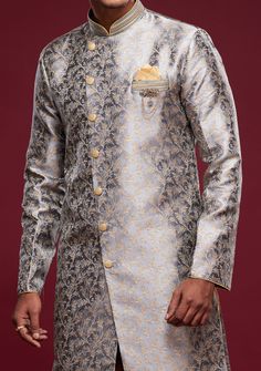 Ready-Made Sherwani With Peshawari Trouser. All Over Jacquard Brocade Style Fabric Top. Art Silk Peshawari Ready Made Trouser. Crafted in Chinese Collar Neck, and Full Sleeve. Satin Lining with Plain Work. High-Quality Matching Buttons. Please Note: The footwear shown in the picture is for presentation and photography purpose only. Color: There might be slight color variation due to lightings and flashes while photo shooting. The color may also vary because of different screen resolutions. Wash Transitional Brocade Salwar Kameez With Dabka Detailing, Brocade Nehru Jacket For Diwali Designer Wear, Diwali Brocade Nehru Jacket For Designer Wear, Diwali Designer Brocade Nehru Jacket, Designer Brocade Churidar For Transitional Season, Formal Long Sleeve Raw Silk Churidar, Formal Salwar Kameez For Eid With Traditional Drape, Bollywood Brocade Nehru Jacket For Festive Occasions, Bollywood Style Formal Kurta With Zari Work