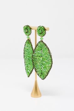 The Lavish by TM Green Leaf Earrings are beautiful addition to any outfit! Material: Enameled wire, hypoallergenic and nickel-freeOrigin: Hand made in Brazil Stud closure Hand crocheted Lightweight 3.5" drop Lavish by Tricia Milaneze is ethereal and lace designs are ideal for women looking for an attractive accessory, but avoiding solid, heavy jewelry. All pieces are extremely feminine, wearable and accessible. Green Metal Beaded Earrings For Party, Green Metal Beaded Party Earrings, Elegant Green Hypoallergenic Beaded Earrings, Heavy Jewelry, Lace Designs, Brand Sale, Made In Brazil, Green Leaf, Lace Design