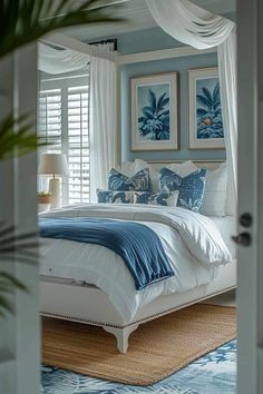 a bedroom with blue walls and white bedding