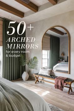 a bedroom with green drapes and a large mirror on the wall over the bed