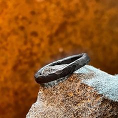 Hand Forged Iron Ring  This ring is made from iron. Forged and beautifully textured by the hammer. You will get a custom ring since they are handmade there a not two alike. The natural color of Iron is grey-silver. The iron is darkend the traditional way by burning it in linseed oil. The iron piece will get patina. The natural color shinning through. Some more and some faster, it depends on the wearer.  The Width Is About 4mm  If Your Size Isn't On The List Don't Hesitate To Message Me Your Ring Artisan Hand Cast Round Rings, Rustic Hand Forged Ring Jewelry, Hand Forged Adjustable Round Band Ring, Rustic Hand Forged Promise Ring, Adjustable Hand Forged Round Band Ring, Rustic Hand Forged Rings For Anniversary, Handmade Black Promise Ring, Adjustable Hand Forged Engraved Ring, Minimalist Hand Forged Black Rings