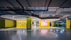 an empty parking garage with yellow and green accents