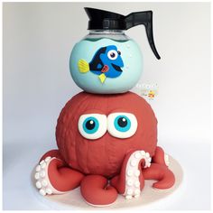 an octopus cake is topped with a blue and orange fish on it's head