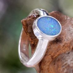 Opal solitaire ring, 'Intensity' - Handcrafted Sterling Silver and Opal Ring Gift Opal Ring With Bezel Setting In Sterling Silver, Classic Opal Jewelry With Polished Finish, Sterling Silver Opal Ring With Bezel Setting As Gift, Silver Opal Ring With Round Stone, Formal Oval Opal Ring In Sterling Silver, Fusion Style Oval Rings With Polished Finish, Fusion Style Round Opal Ring, Modern Round Opal Jewelry, Silver Opal Ring With Bezel Setting For Promise