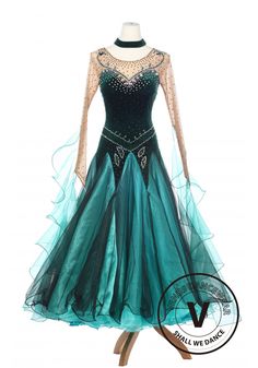 a dress with long sleeves and beading on the neck, in teal blue