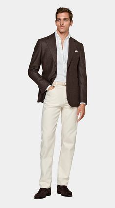 a man in a suit and white pants