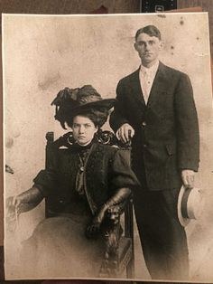 an old photo of two people standing next to each other