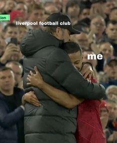 two soccer players hugging each other in front of a crowd with the words liverpool football club me