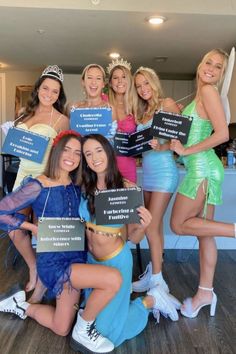 a group of women posing for a photo holding signs