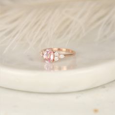 Pop the bubbly! This new version of our Thea ring features a blush champagne sapphire with diamond clusters on each side. #rings #engagementrings #weddingrings #rosadosbox #rosegold #blush #champagne #sapphire #gemstone #diamonds #artdeco #cluster #oval #unique #oneofakind #jewelry #finejewelry #gifts Fine Jewelry Pink Sapphire Wedding Ring, Pink Sapphire Fine Jewelry For Wedding, Heirloom Pink Sapphire Ring For Wedding, Luxury Oval Morganite Wedding Ring, Classic Pink Sapphire Diamond Wedding Ring, Exquisite Pink Sapphire Wedding Ring, Wedding Rings With Pink Sapphire And Accent Stones, Morganite Rings Gia Certified For Anniversary, Timeless Oval Sapphire Wedding Ring