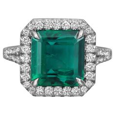 an emerald and diamond ring set in white gold