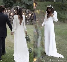 the bride and groom are walking through the grass together, holding hands with each other