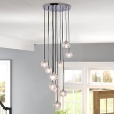 a chandelier hanging from the ceiling in a living room