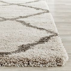 a white and gray rug on the floor