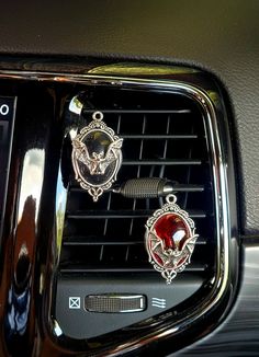 the interior of a car with chrome trim and emblems on it's dashboard