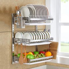 the dish rack is holding many plates and bowls