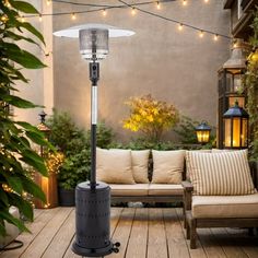 an outdoor patio with couches, lights and potted plants on the deck area