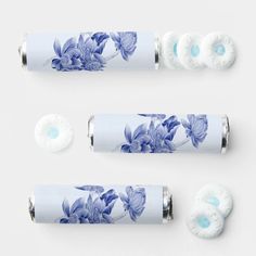 three rolls of toilet paper with blue and white flowers on them, next to each other